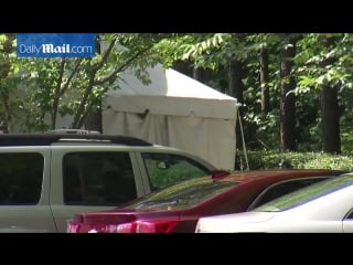 Kim kardashian shows off baby bump in skintight nude dress