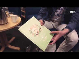 Tarjei showing a book with his life story | skamfamily