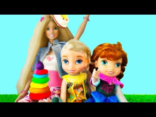 Funny doll elsa and anna toddlers play with pyramid on birthday party