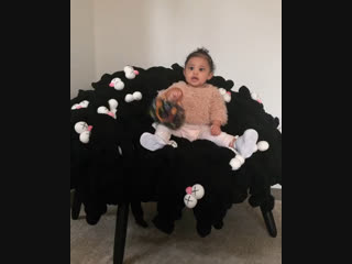 Stormi on kaws chair