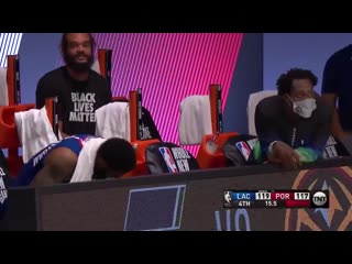 Patrick beverley and marcus morris react to damian lillards missed free throws on the clippers bench