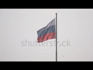 Stock footage three color russian flag on the background of the volga in volgograd