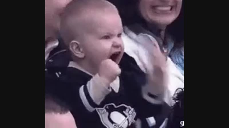 Overly excited baby at a hockey game