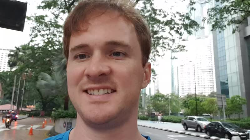 Walking along jalan ampang towards petronas towers in kuala lumpur, malaysia