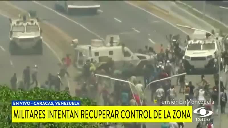 Breaking a military vehicle runs over pro guaido protesters in caracas, venezuela