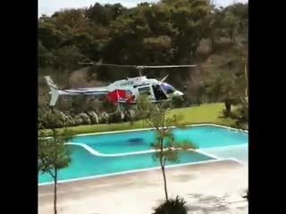A helicopter from the “policia del proteccion civil, jalisco”, borrows water from a local hotel while fire fighting at “del bosq