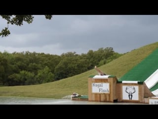 Girl does a backflop from waterslide