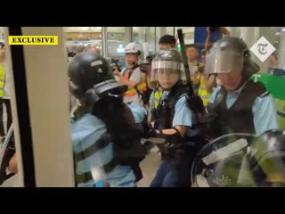 Hong kong policeman draws pistol on protesters after being beaten with own baton