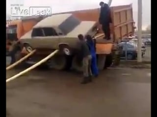 Unloading a car from a truck with russian style