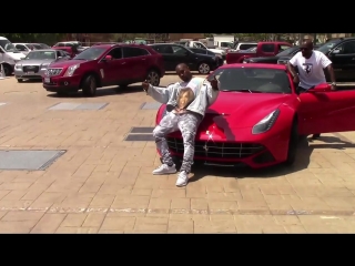 Kanye west showing off new red ferrari with corey gamble