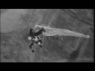 Students of a naval parachute jumping school jump from a blimp while in flight at hd stock footage