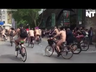 Nowthis hundreds of naked people are riding their bikes through