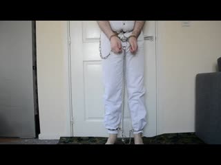 Handcuffed shackled in prison jumpsuit