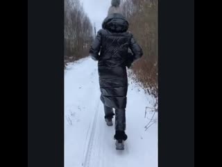 Rocking her butt in a black shiny puffer coat