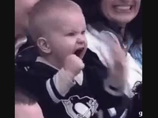 Overly excited baby at a hockey game