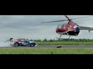 Aerobatic helicopter chases drifting race car