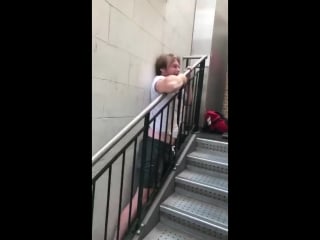 Lad stuck in between the stair banister and the wall