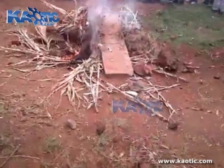 Cooking of a man in africa on a makeshift bonfire stove