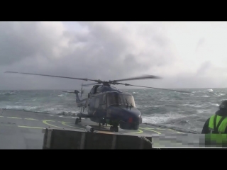 Lynx helicopter landing on ship in rough sea