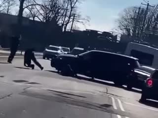 Guy steals cop car, runs over two cops, gets shot at, smashes through fence and drives through cemetery