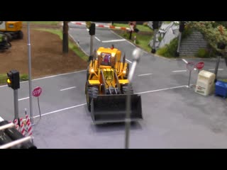 Miniature micro rc excavator with full functionality in scale 1 87 in motion on a diorama