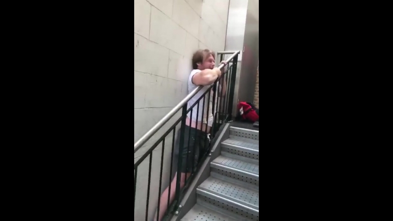 Lad stuck in between the stair banister and the wall