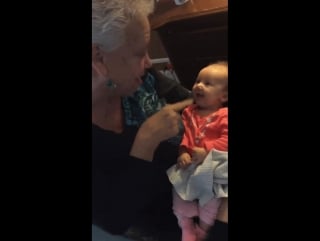 Grandma teaching sign language to her grandchild