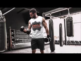 Parallax video of a muscled man lifting weights at a boxing gym 26346 mp4