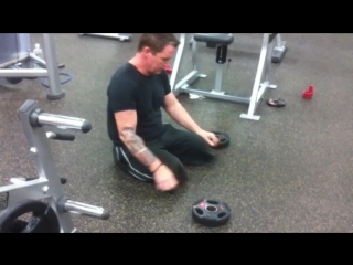 Bilateral above knee amputee walking on stumps in gym