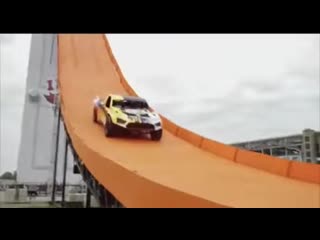 Driver, tanner foust, drops down 90 feet of orange track and soars 332 feet through the air