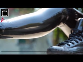 Skateboard girl in shiny latex