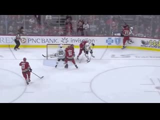 Andrei svechnikov lays a big hit on kirby dach behind the carolina net