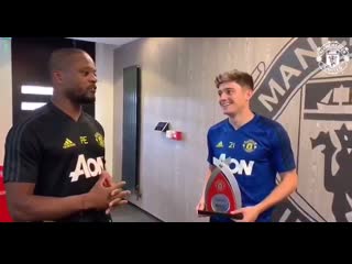 Patrice evra presents daniel james with the player of the month award