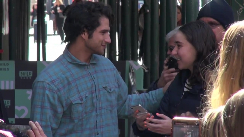 Tyler posey from the film truth or dare signs autographs and poses for photos with fans as he leaves