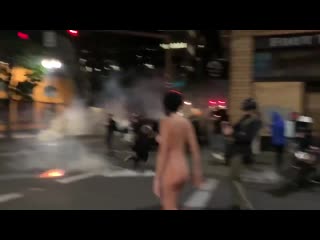 Nude woman standing before riot police in portland she's been nicknamed "naked athena"