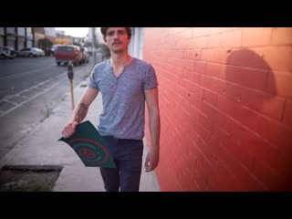 Stop motion featuring a hipster man holding a poster held in the street 13653 mp4