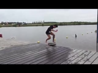 Guy rides skimboard across dock and jumps into water 987085 1