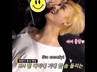 Taehyung wearing a white shirt while he lil dancing and smiling widely also resting his he