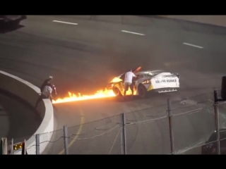 Dad rushes on the track to free his son from burning racecar