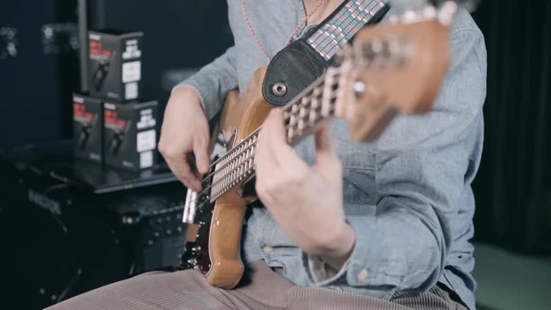 The bass player playing nux mighty plug 2