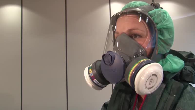 Girl is donning hazmat suit and gasmask