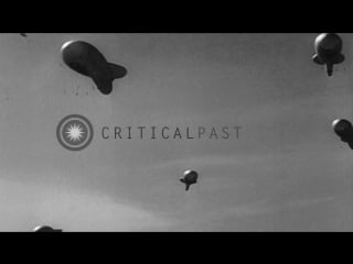 Enemy airplanes in flight drop bombs and barrage balloon in sky in the united stock footage