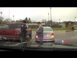 Dashcam police officer helps speeding student tie his tie