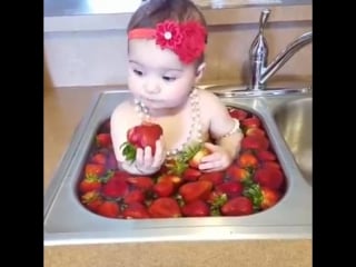 Baby bathes with strawberries