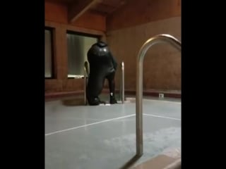 Guy attempts to empty wetsuit full of water