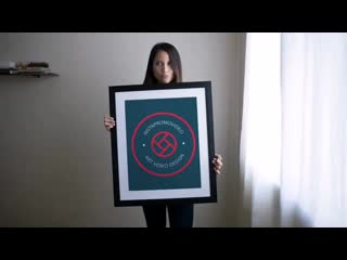 Beautiful girl holding a big framed art print video while doing faces a14358 mp4