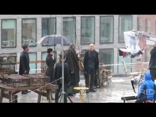 Laurence fishburne and mark dacascos face off on a rainy rooftop building for