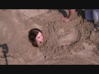 Buried in sand and handcuff roxanne